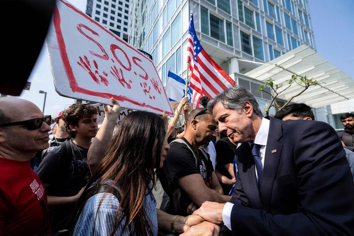 US Secretary of State Antony Blinken (right) meets with the families of hostages kidnapped by Palestinian militants, as they gather outside a hotel in Tel Aviv on May 1, 2024. 