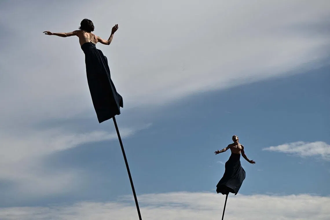 Performers of the French aerial theatre company "Gratte Ciel" balancing on stilts during a performance at the 10th edition of the FAB International Arts Festival in Bordeaux, south-western France on Sept 27, 2025. 