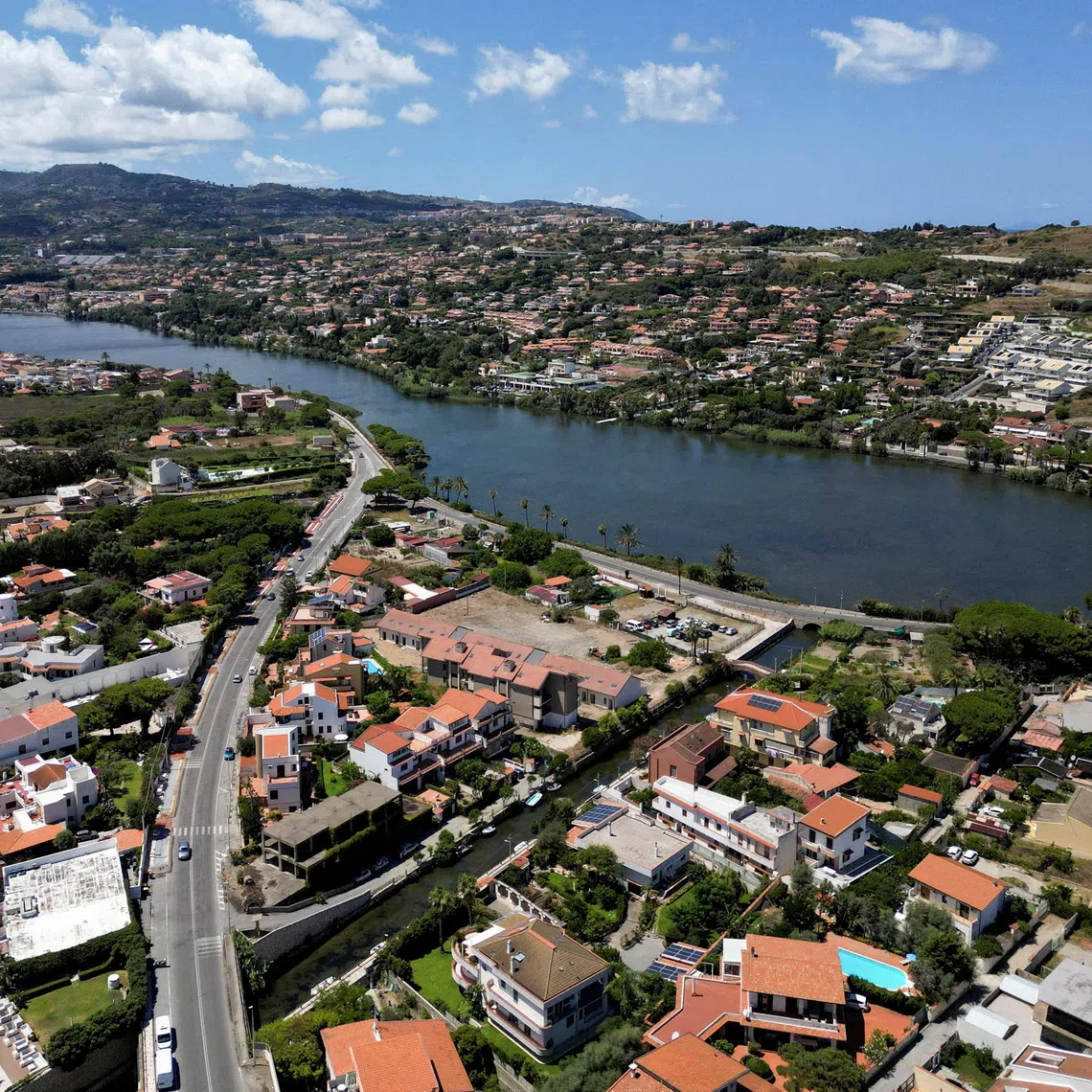 FILE PHOTO: A drone view shows Lake Ganzirri, part of the planned site for the construction of a suspension bridge along the Strait of Messina, connecting Sicily to mainland Italy, with construction expected to be completed by 2032, in Messina, Italy, August 5, 2025. REUTERS/Yara Nardi/File Photo