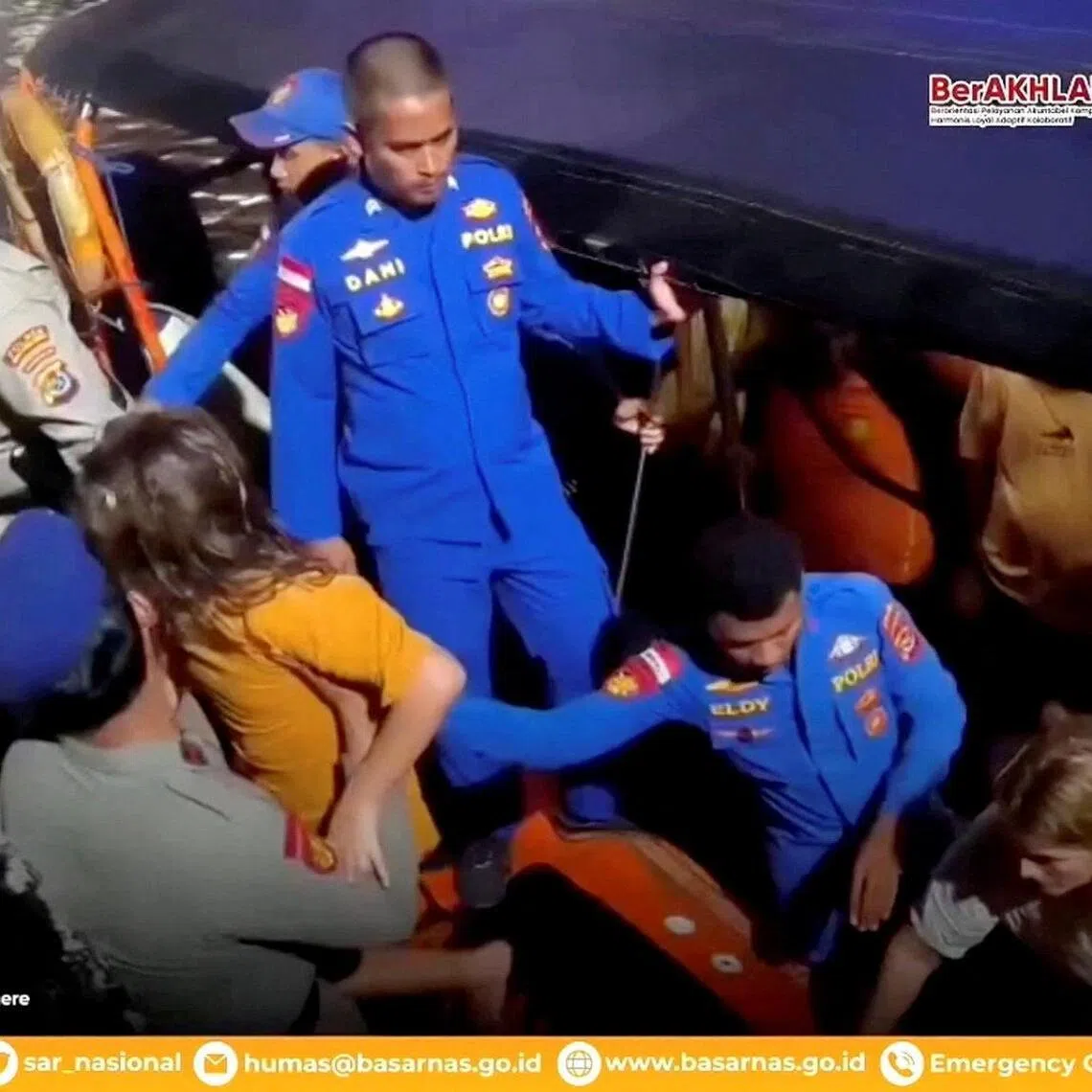 Rescue teams help to depart the rescued, as Indonesia's National Search and Rescue Agency (BASARNAS) said, after a boat carrying several people sank off the coast of Indonesia in extreme weather, Spanish authorities and an Indonesian news agency said, in Indonesia, in this screengrab from the video obtained by Reuters on December 27, 2025. A Spanish family, father and three of his children, have been missing since Friday night when the boat capsized in waves of up to three meters in the Padar Island Strait. Indonesia's National Search and Rescue Agency (BASARNAS)/Handout via REUTERS THIS IMAGE HAS BEEN SUPPLIED BY A THIRD PARTY. MANDATORY CREDIT. OVERLAYS FROM SOURCE.