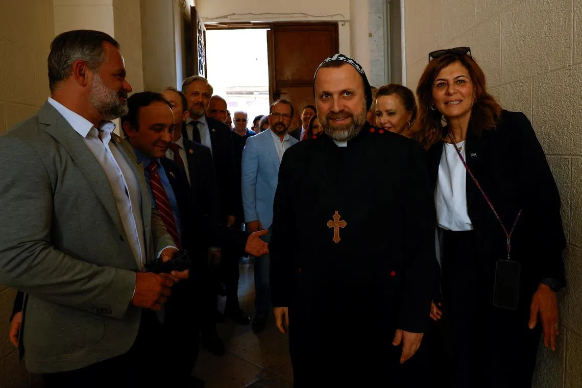 U.S Congressman Cory Mills stands next to a member of the clergy, on the day he meets Syriac Orthodox Patriarch Mor Ignatius Aphrem (not pictured), in Damascus, Syria April 18, 2025. REUTERS/Yamam Al Shaar