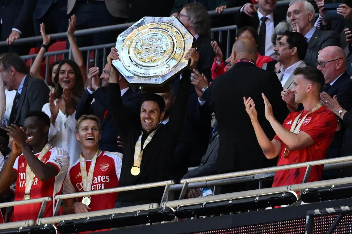 Arsenal manager Mikel Arteta with the Community Shield after beating Manchester City on penalties.