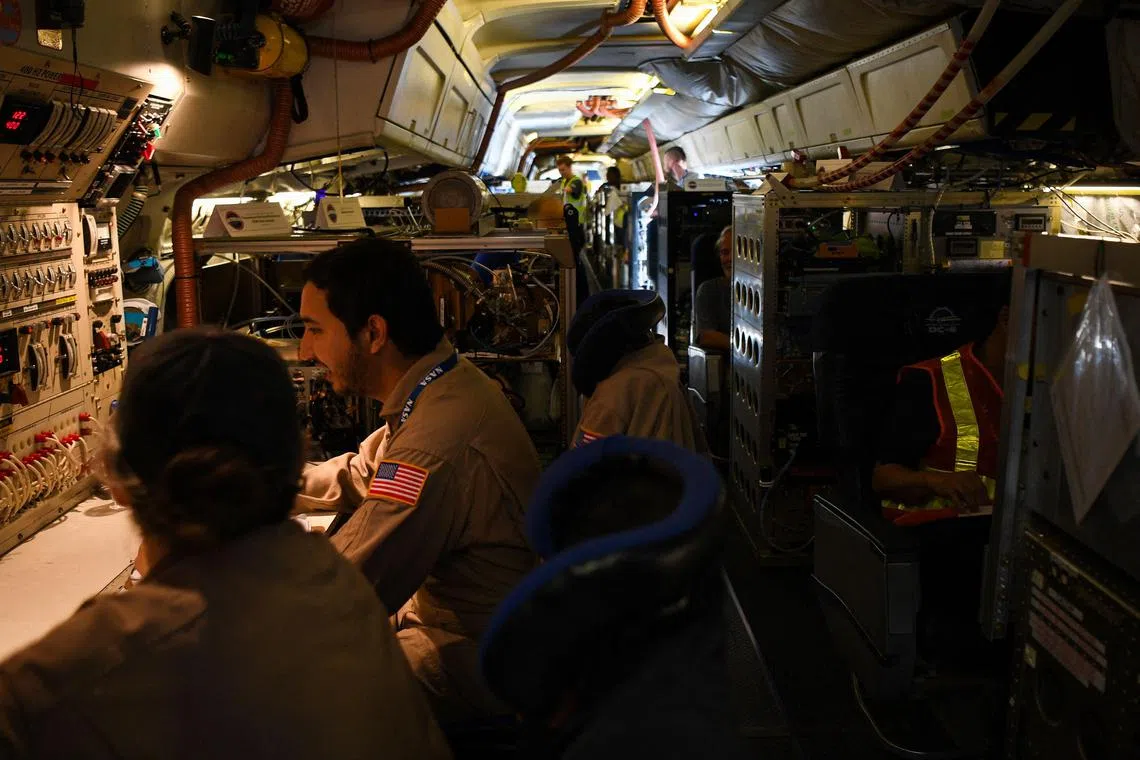 Crew and scientists of the National Aeronautics and Space Administration's (NASA) DC-8 airborne science laboratory work inside the aircraft at Clark International Airport in Angeles City, Pampanga province, north of Manila, on February 8, 2024. The world's biggest flying laboratory is in Asia to improve the measurement and forecasting of air pollution in the most populous region of the planet, governments involved in the project said Thursday. (Photo by Ted ALJIBE / AFP)
