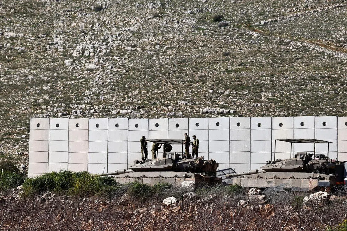 FILE PHOTO: Israeli soldiers work on their tank on the Israeli side of the Israel-Lebanon border, amid escalation between Hezbollah and Israel, and amid the U.S.-Israeli conflict with Iran, in northern Israel, March 10, 2026. REUTERS/Amir Cohen/File Photo