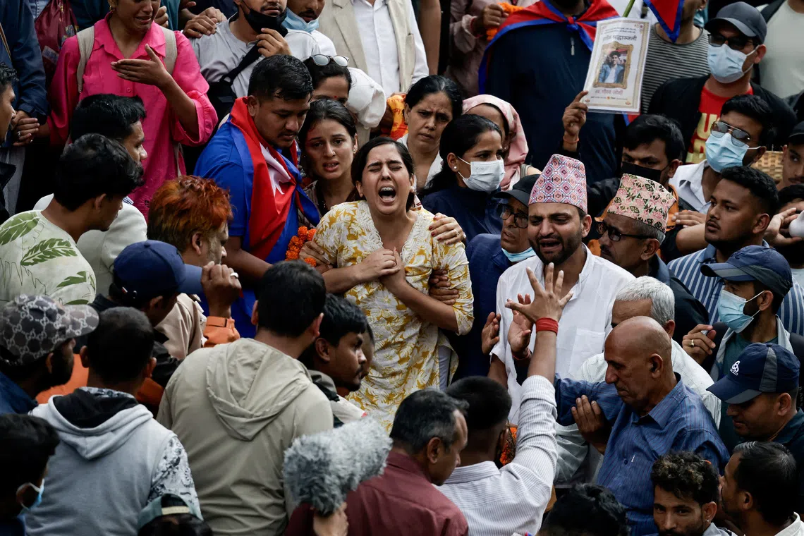 Sister of a person, who died in last week's anti-corruption protests that toppled the government, mourns during the final rites before the cremation on the premises of Pashupatinath temple,  in Kathmandu, Nepal, September 16, 2025. REUTERS/Navesh Chitrakar