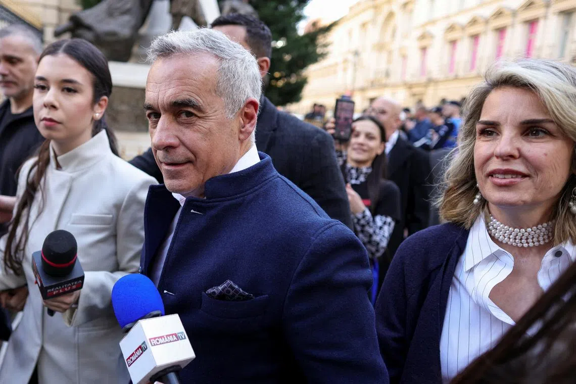 Calin Georgescu and his wife Cristela Georgescu arrive at the Central Electoral Bureau where Georgescu submitted his candidacy for the May presidential ballot re-run, in Bucharest, Romania, March 7, 2025. Inquam Photos/Octav Ganea via REUTERS/File Photo