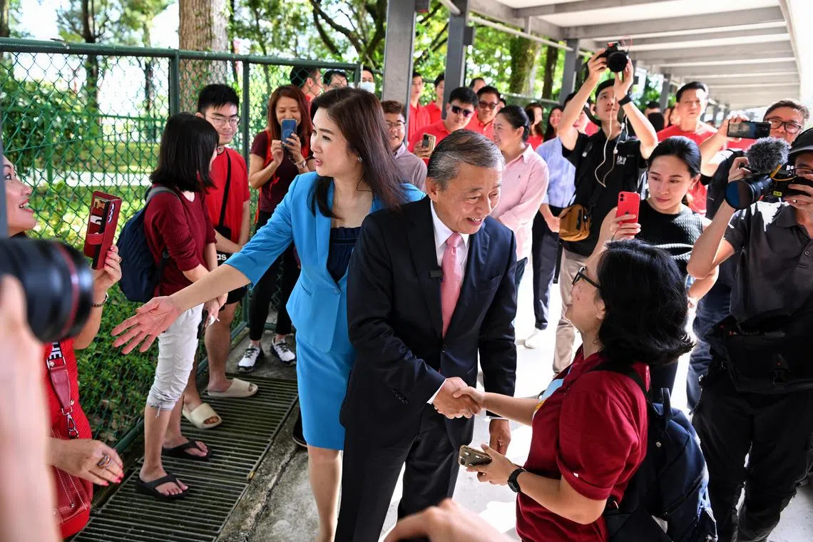 Entrepreneur George Goh collecting his papers to apply for the presidency at the Elections Department on June 13, 2023. He is accompanied by his wife, Lysa Sumali (in blue) and children, Jovina, Joanna, Ingrid and Jonathan as well his supporters, dressed in red.