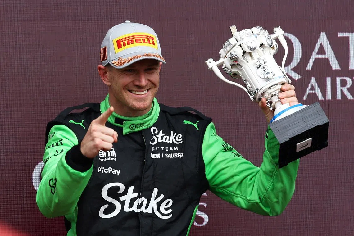 Formula One F1 - British Grand Prix - Silverstone Circuit, Silverstone, Britain - July 6, 2025 Sauber's Nico Hulkenberg celebrates with a trophy on the podium after finishing third place in the British Grand Prix REUTERS/Andrew Boyers