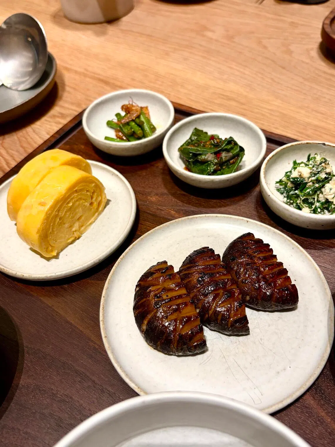 The beef gomtang comes with sweet corn gyeran mari and charcoal-grilled shiitake mushrooms. 