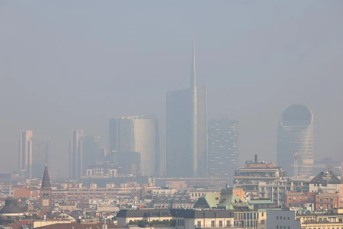 General view of high-rise buildings, UniCredit tower and Vertical Forest building, shrouded in smog in Milan, Italy, February 20, 2024. REUTERS/Claudia Greco