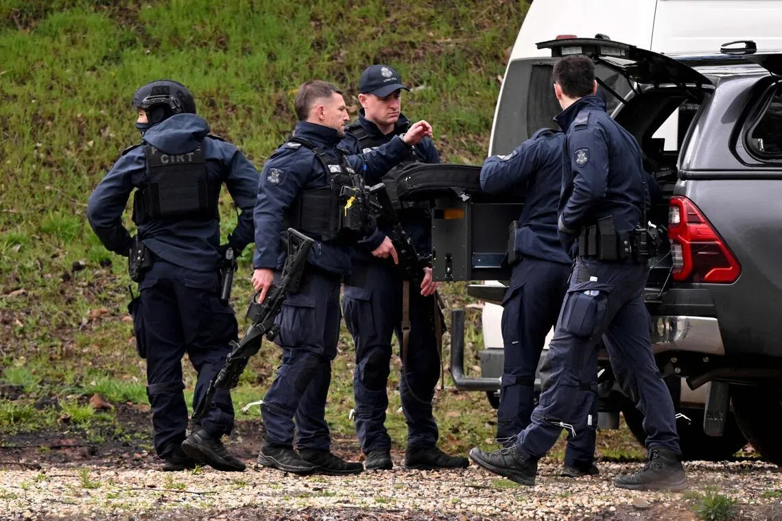Heavily armed police gather at a staging point during a search for a fugitive linked to the murder of two police officers, in Porepunkah on Aug 29, 2025.