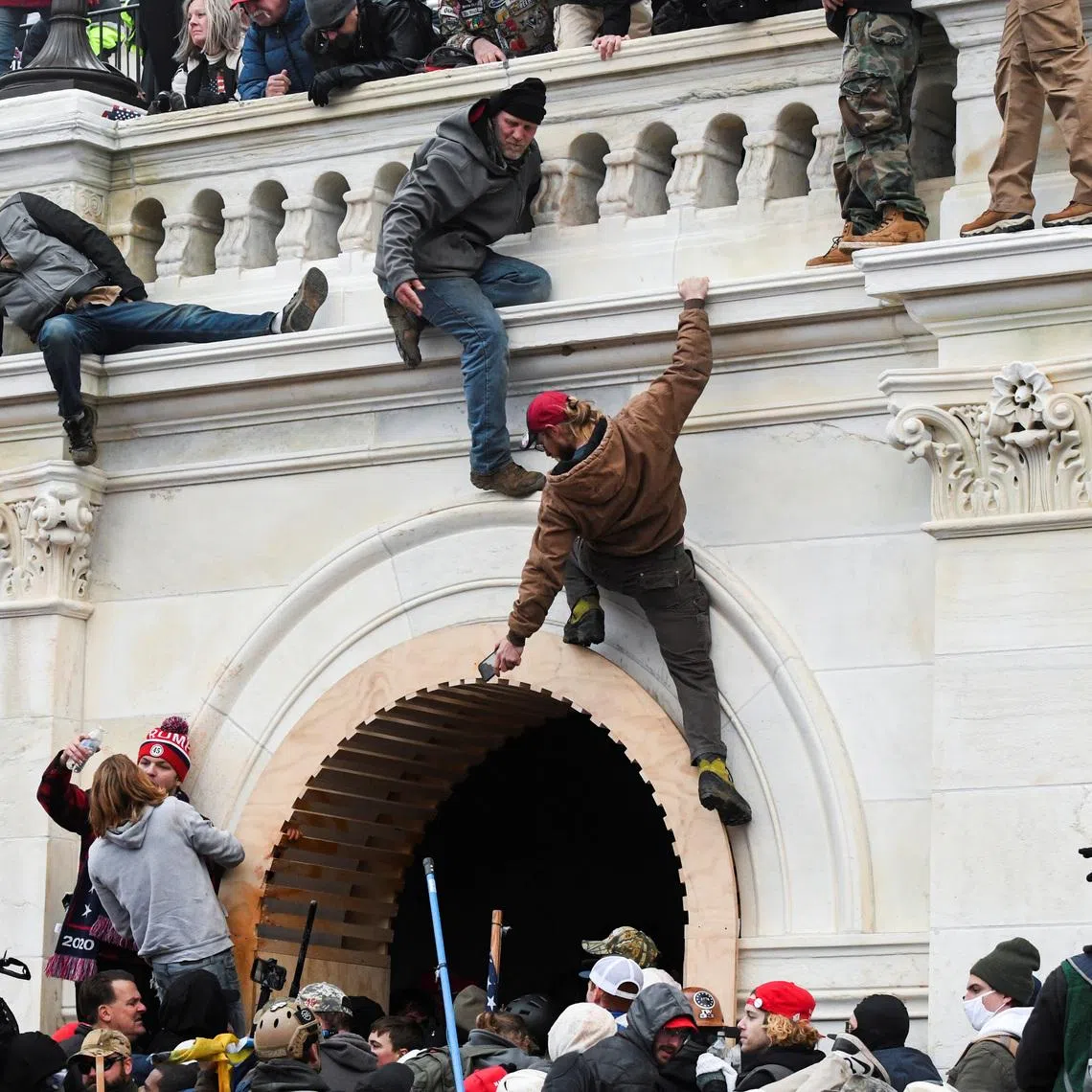 Supporters of U.S. President Donald Trump climb on walls at the U.S. Capitol during a protest against the certification of the 2020 U.S. presidential election results by Congress, in Washington, January 6, 2021. REUTERS/Stephanie Keith