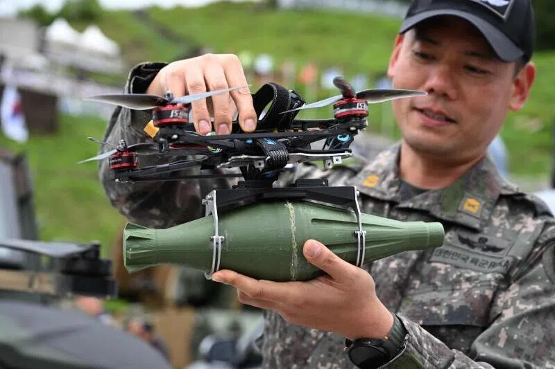 A South Korean soldier holds a multi-purpose tactical drone during a live-fire military exercise on May 21. Emerging security threats, from quantum technology to drone warfare, urgently need to become mainstream conversations, the writer argues. 