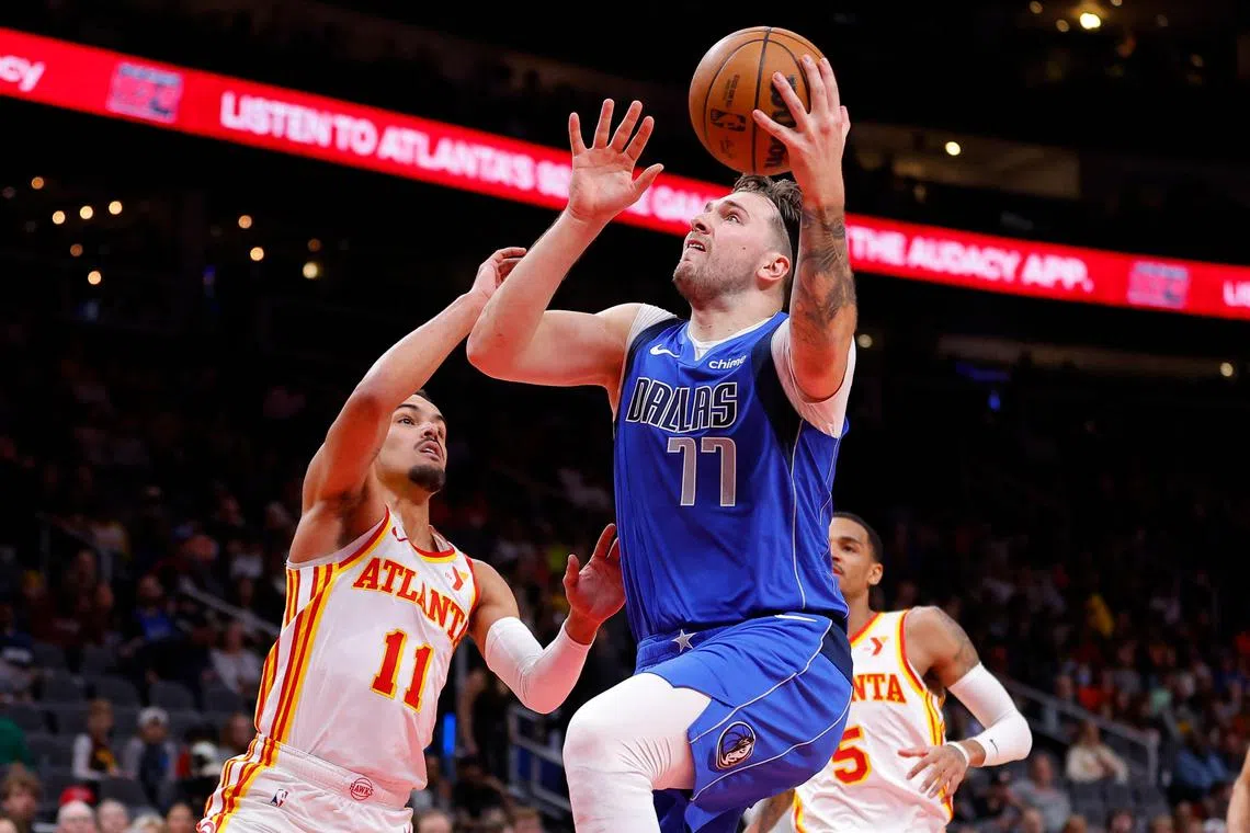 Luka Doncic of the Dallas Mavericks goes up for a shot against Trae Young of the Atlanta Hawks during the first quarter at State Farm Arena.