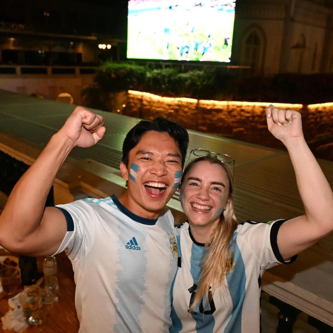 Rio Hoe (left), 33, a Singaporean, and his Argentinian wife Guadalupe Lazaro, 28, at the live screening of the England v Argentina match at CHIJMES on July 16.