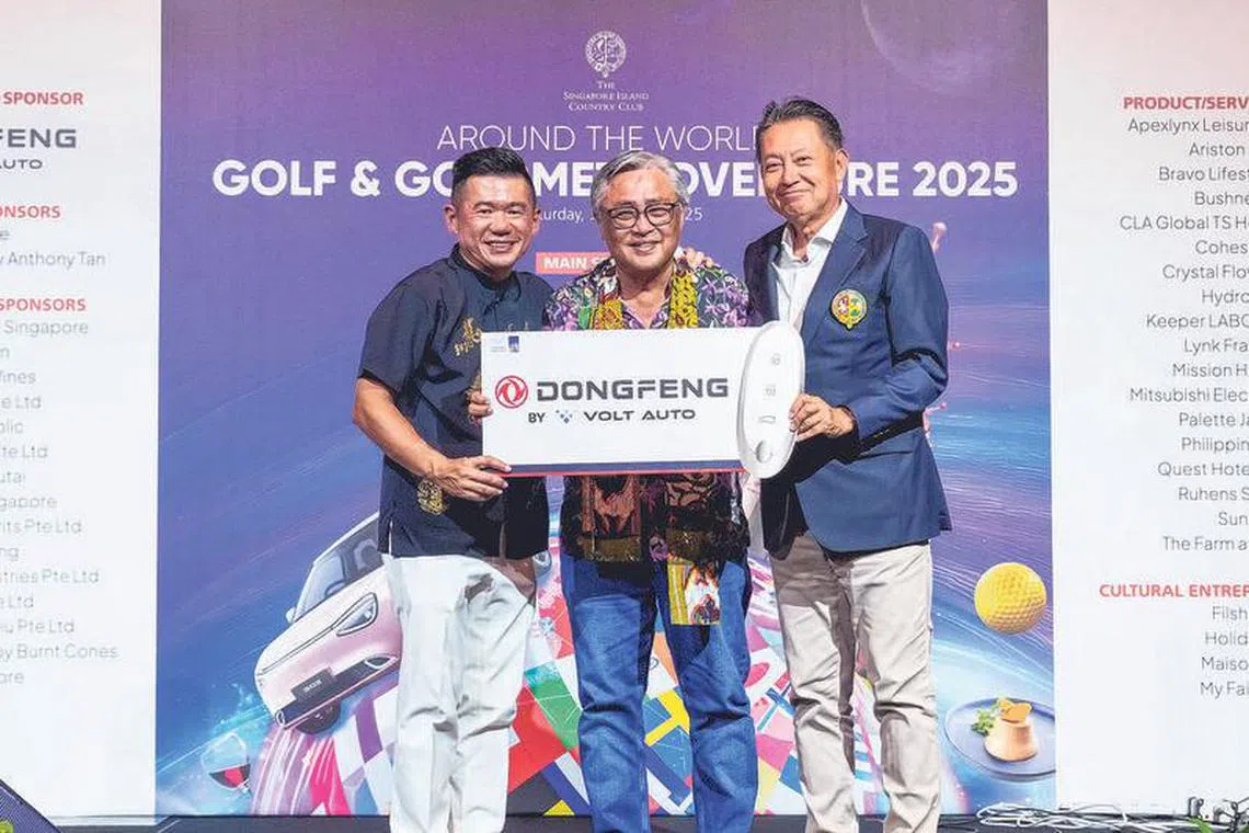 Lucky draw main prize winner Benny Tay (centre) receiving his validation from Volt Auto executive director Jackson Lim (far left) and SICC vice-president Yoshihiro Hirooka.