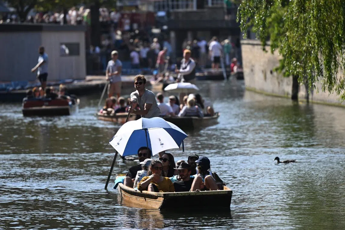 (FILES) People enjoy the sunshine while punting on the River Cam in Cambridge, north of London on September 9, 2023, as the late summer heatwave continues. Last month was the world's hottest September on record by an "extraordinary" margin, adding to record-breaking global temperatures during the Northern Hemisphere summer, the EU climate monitor said on Thursday. (Photo by JUSTIN TALLIS / AFP)