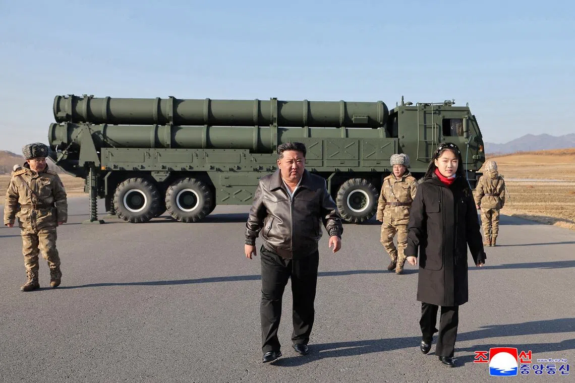 North Korean leader Kim Jong Un, accompanied by his daughter Kim Ju Ae, directs a test of a large-caliber multiple-rocket launch system, in an unknown location, North Korea, January 27, 2026, in this picture released by North Korea's official Korean Central News Agency on January 28, 2026.    KCNA via REUTERS