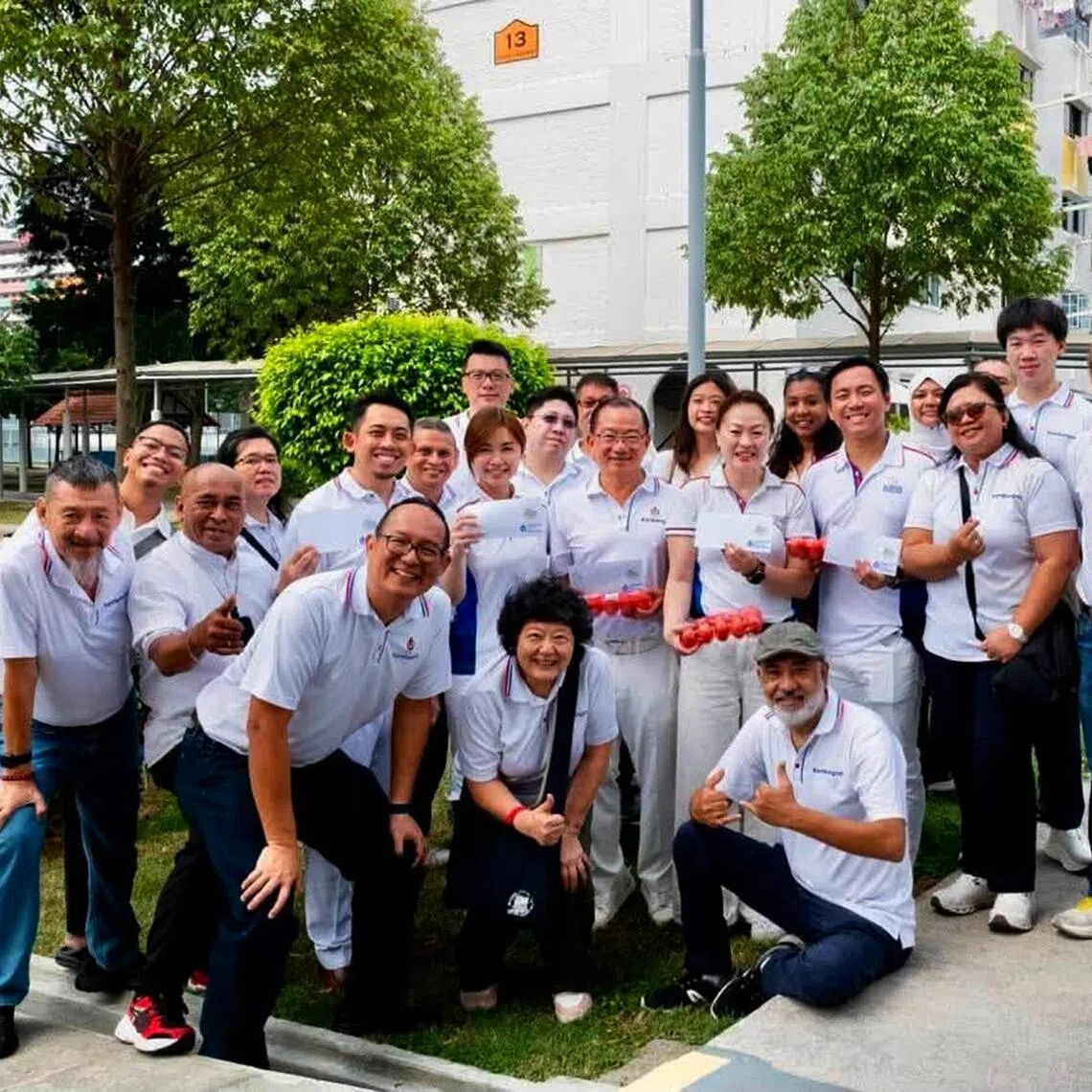 Lawyer and GE2025 reserve candidate Firdaus Daud (left of Tin Pei Ling) with Marine Parade-Braddell Heights GRC MPs at a voucher distribution event on Aug 23.