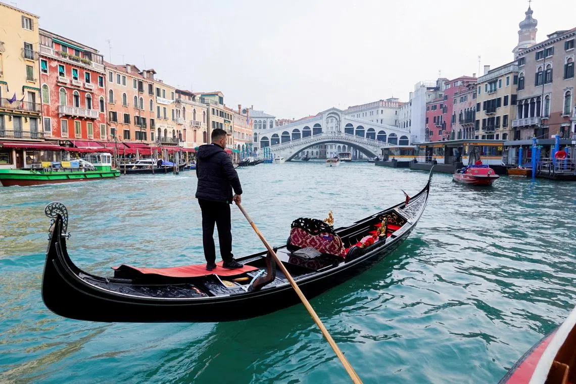 FILE PHOTO: A gondola is pictured on Grand Canal in front of Rialto bridge in Venice, Italy, October 20, 2021. REUTERS/Fabrizio Bensch/File Photo
