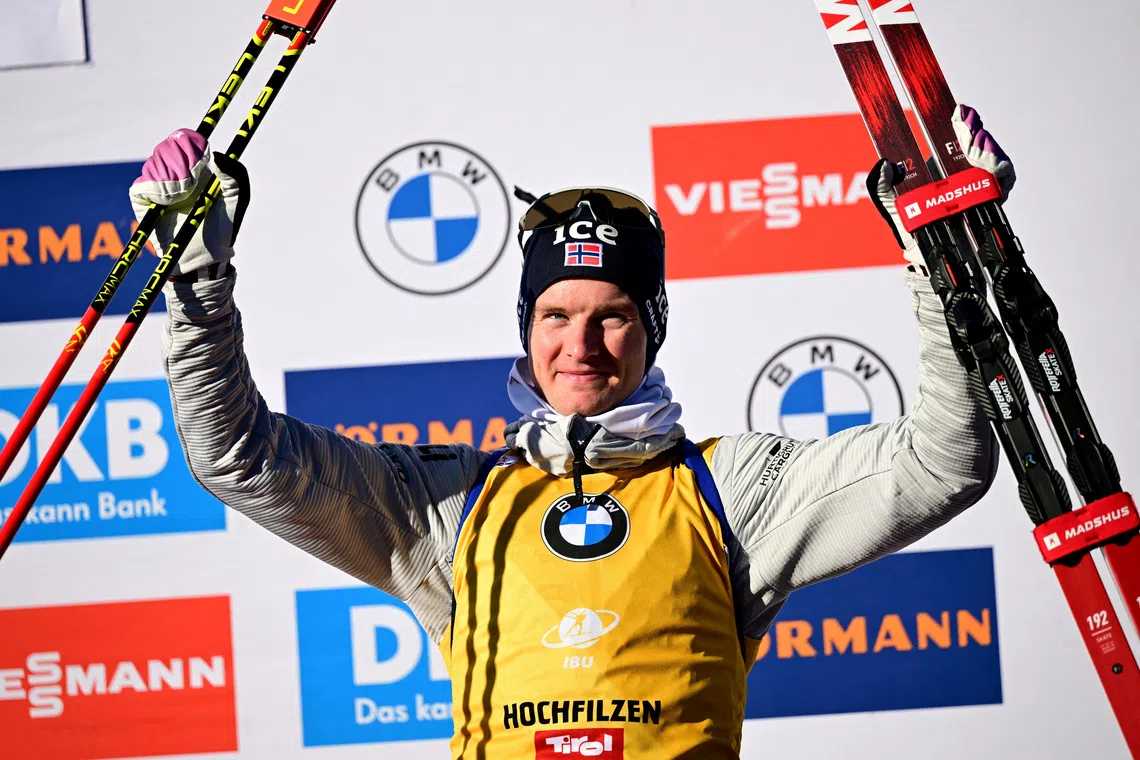 Biathlon - Biathlon World Cup - Hochfilzen, Austria - December 13, 2025 Men's 12.5km pursuit bronze medallist, Norway's Johan-Olav Botn celebrates on the podium REUTERS/Christian Bruna