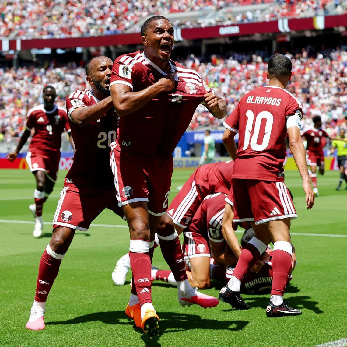 Soccer Football - FIFA World Cup 2026 - Group B - Qatar v Switzerland - San Francisco Bay Area Stadium, Santa Clara, California, U.S. - June 13, 2026 Qatar's Pedro Miguel and Ahmed Fathy celebrate after Boualem Khoukhi scored their first goal REUTERS/Carlos Barria