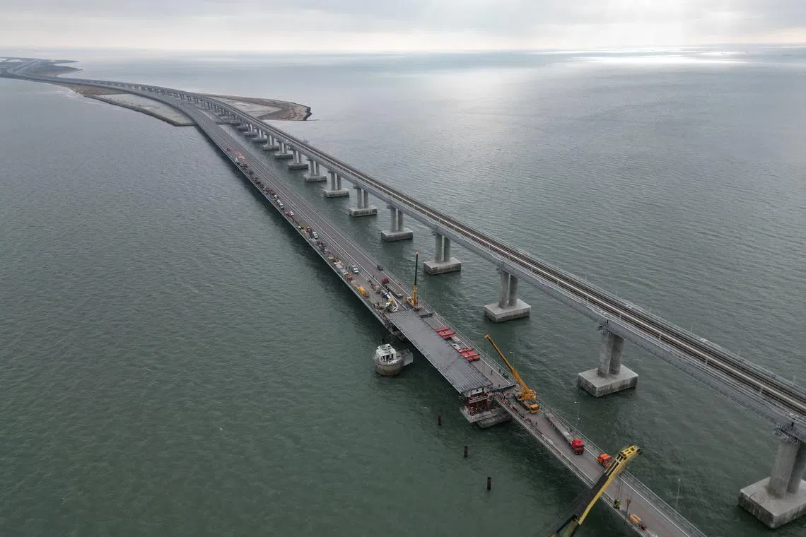 Restoration works on Nov 8 on damaged parts of the Kerch Bridge that links Crimea to Russia, which was hit by a blast in October.