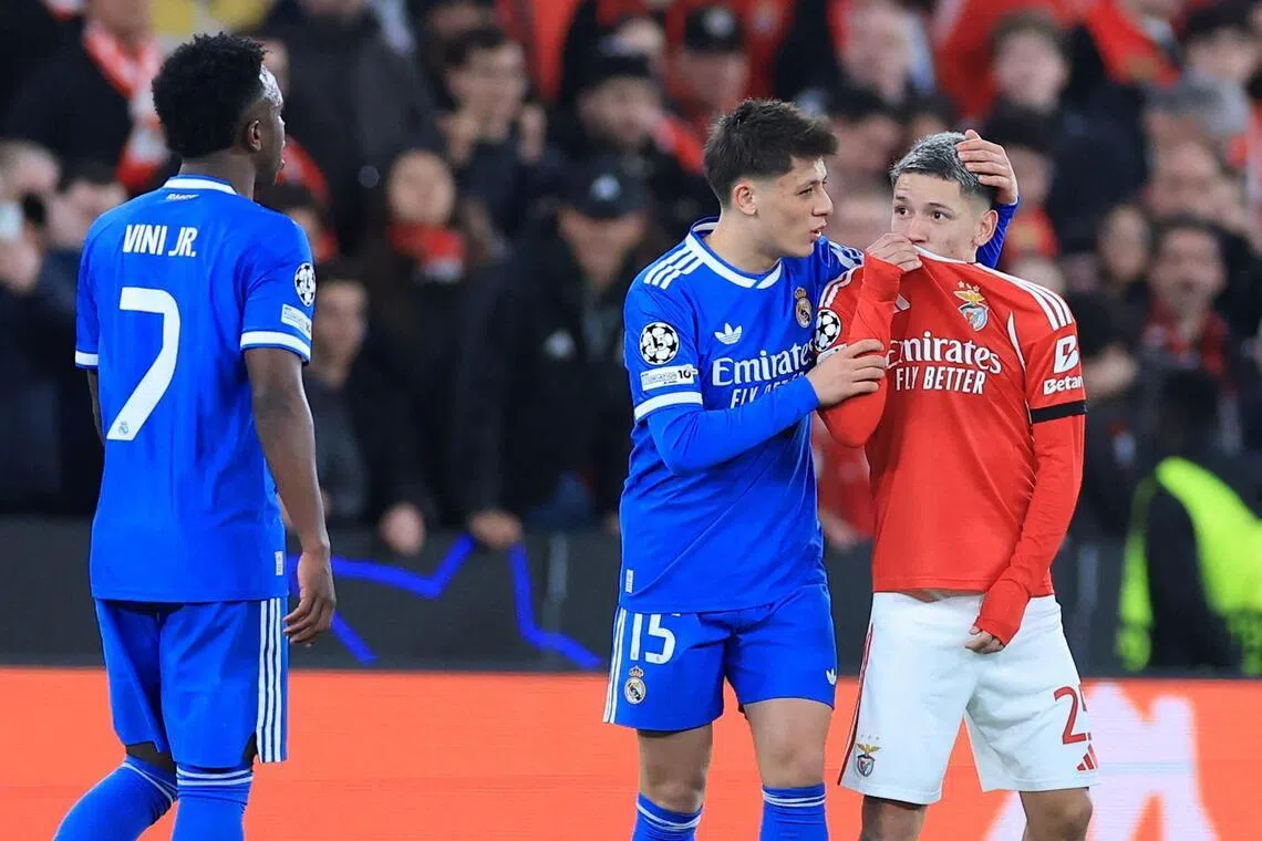 Benfica's Argentinian winger Gianluca Prestianni hiding his mouth while arguing with Real Madrid's Brazilian forward Vinicius Jr, who complained about alleged racists insults during the Champions League knockout round play-off, first-leg football match at the Estadio da Luz in Lisbon on Feb 17, 2026. 