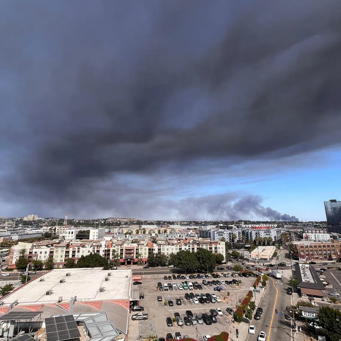 Black smoke rises from a warehouse fire in Boyle Heights as seen from downtown Los Angeles on June 17.