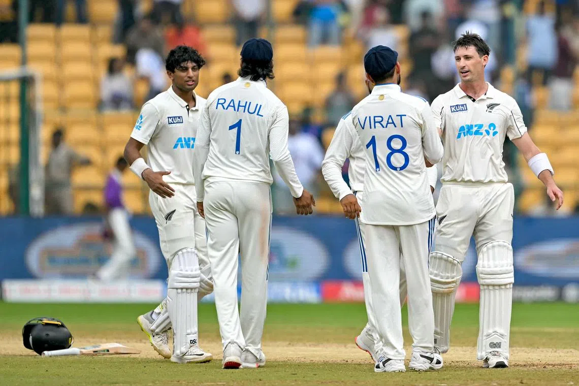 New Zealand's Rachin Ravindra and Will Young are congratulated by India's Virat Kohli and K.L. Rahul after their team won the first cricket Test at the M. Chinnaswamy Stadium in Bengaluru on Oct 20, 2024.
