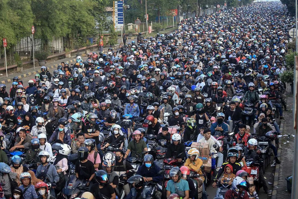 Motorcyclists waiting to board a ferry to cross the Sunda Strait to return home ahead of Eid al-Fitr, which marks the end of the Muslim fasting month of Ramadan, at Ciwandan port in Cilegon, Indonesia, on April 7, 2024. 