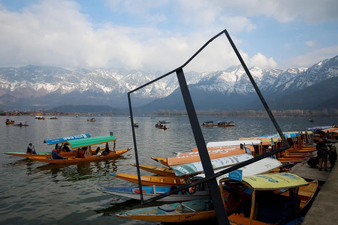 Tourists riding shikaras, or traditional boats, in the waters of Dal Lake on a cold winter day in Srinagar, Indian Kashmir on Feb 4, 2026.