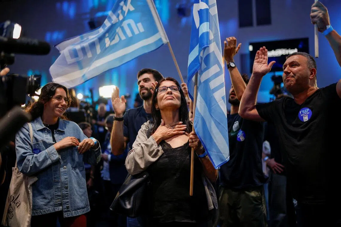 Supporters of former military chief Gadi Eisenkot, leader of the Yashar party, react to the exit poll at his party headquarters in Tel Aviv, on Oct 27.