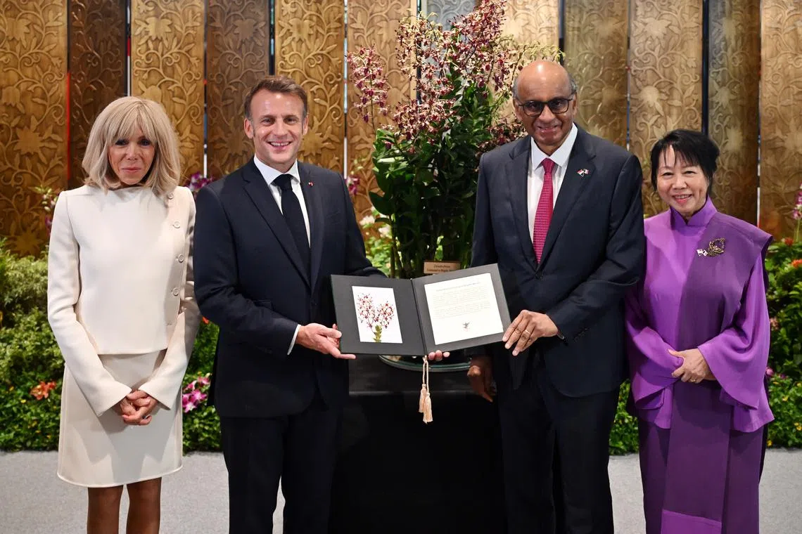 President Tharman Shanmugaratnam and French President Emmanuel Macron with their spouses, Ms Jane Ittogi Shanmugaratnam (right) and Ms Brigitte Macron (left), at a ceremony at the Parliament House on May 30.