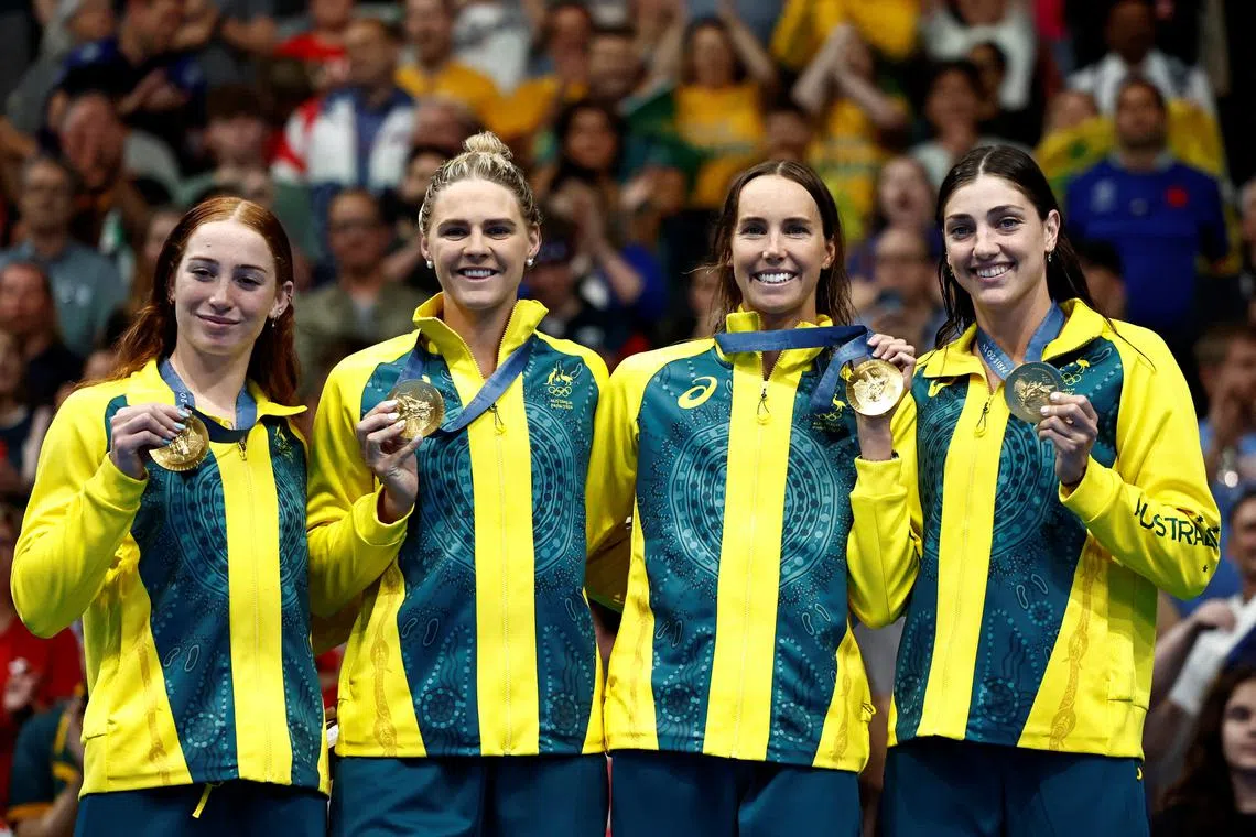 Paris 2024 Olympics - Swimming - Women's 4x100m Free Relay Victory Ceremony - Paris La Defense Arena, Nanterre, France - July 27, 2024. Gold medallists Mollie O'Callaghan of Australia, Emma McKeon of Australia, Meg Harris of Australia, Shayna Jack of Australia celebrate on the podium after winning the race. REUTERS/Clodagh Kilcoyne