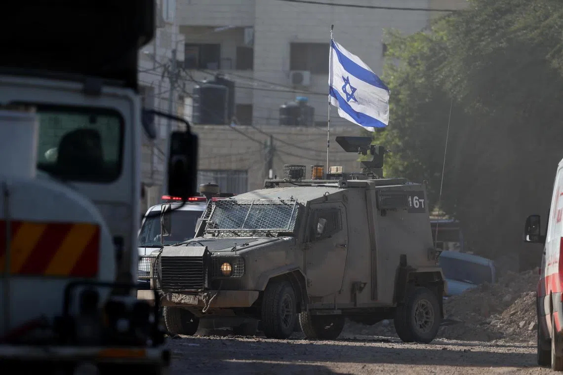 Israeli forces stopping a Palestinian ambulance on Jan 29, during the ninth day of an Israeli military operation in the West Bank city of Jenin. 