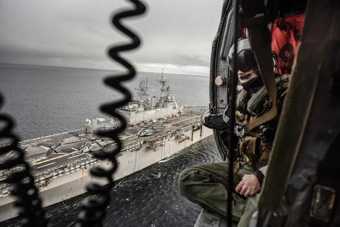 A 2018 photo shows a US assault ship and  an SH-60 helicopter taking part in Nato exercises in the sea off Norway.