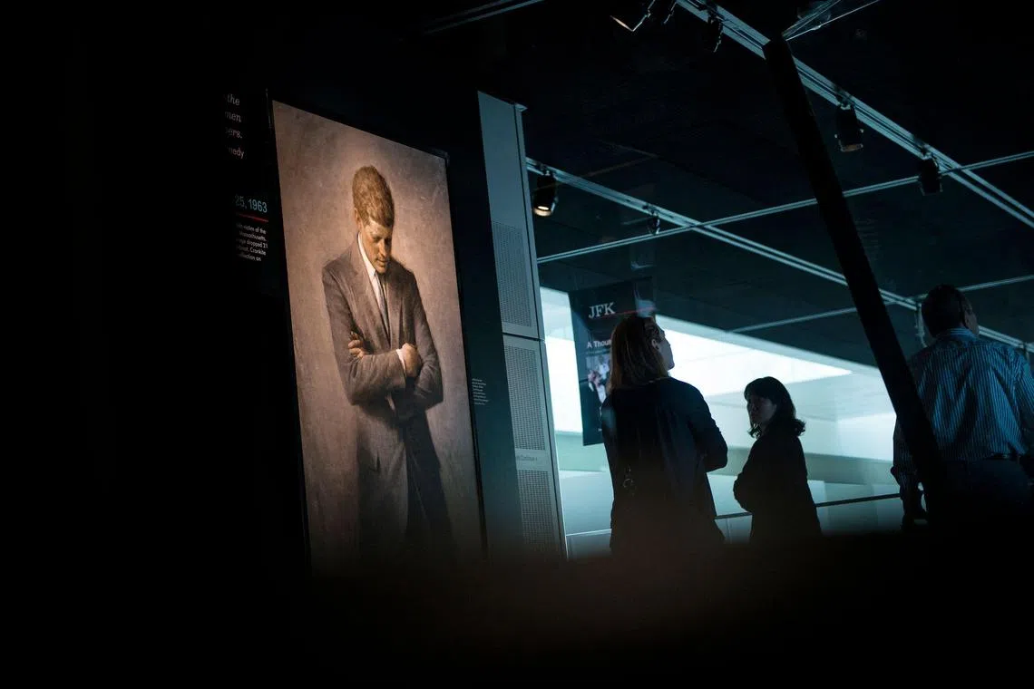 (FILES) In this file photo taken on September 26, 2013, people view an exhibit about the 1963  assassination of former US president John F. Kennedy at the Newseum in Washington, DC. - The US National Archives released on December 15, 2022 a new trove of files related to the November 1963 assassination of president John F. Kennedy. A total of 12,879 documents were made public, the archives said, but thousands more were blocked from release by the White House, citing national security concerns. (Photo by BRENDAN SMIALOWSKI / AFP)