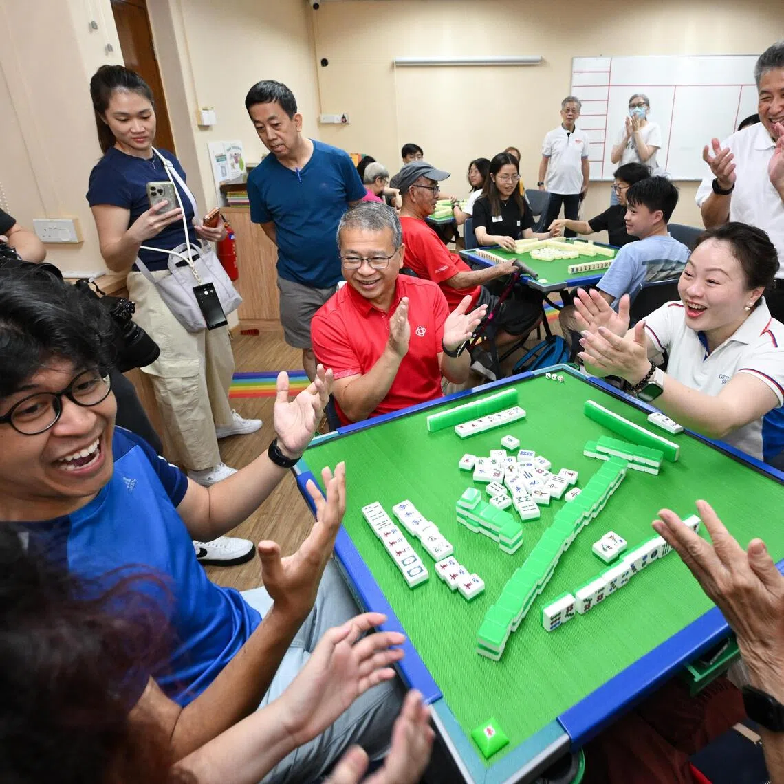 Marine Parade-Braddell Heights GRC MP Diana Pang (centre, right) and  Law Minister Edwin Tong (centre, left) during an intergenerational mahjong session on Sept 27.