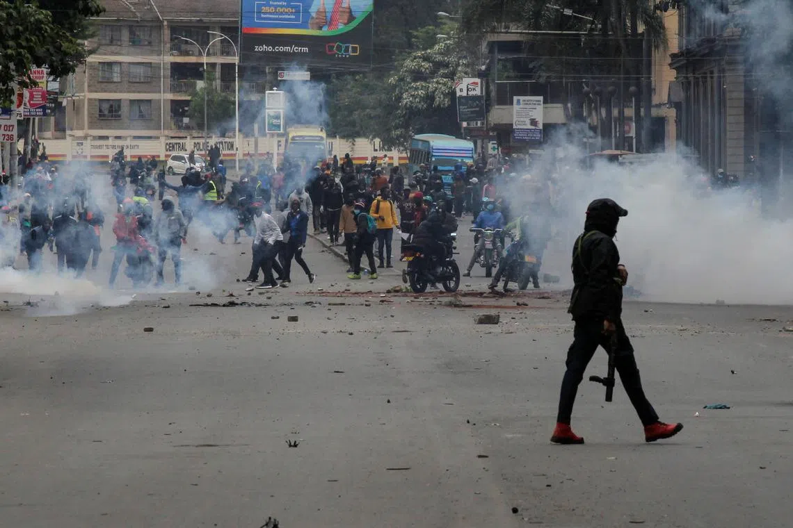 A police officer walks after using tear gas to disperse protesters during a demonstration over police killings of people protesting against Kenya's proposed finance bill 2024/2025, in Nairobi, Kenya, June 27, 2024. REUTERS/Monicah Mwangi/File Photo