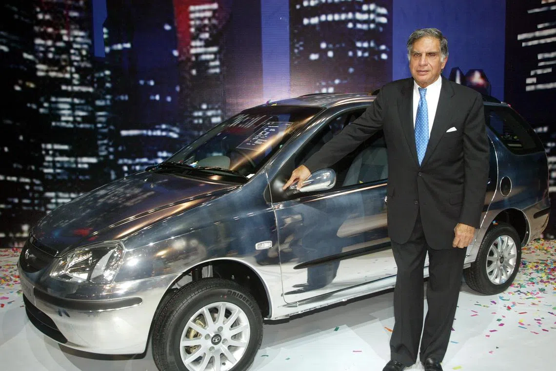 FILE PHOTO: Ratan Tata, chairman of Tata Motors Ltd, poses with company's new estate version Indigo 'Marina' car, during its launch in Bombay September 15, 2004. REUTERS/Punit Paranjpe/File photo