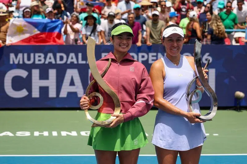 Champion Alexandra Eala (left) holds the championship trophy alongside runner-up Jessica Pegula after the Mubadala DC Open final on Aug 3.
