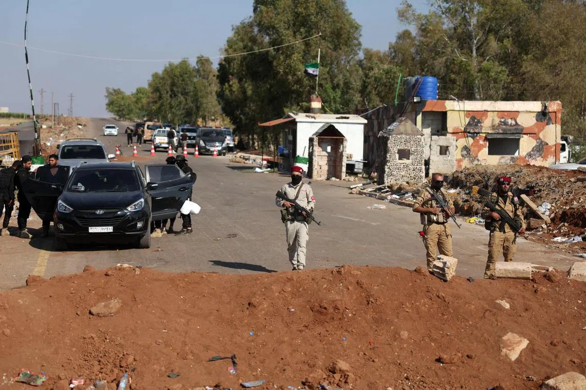 Syrian government security forces during their deployment in Busra al-Harir in Syria's southern Daraa province, on July 21.