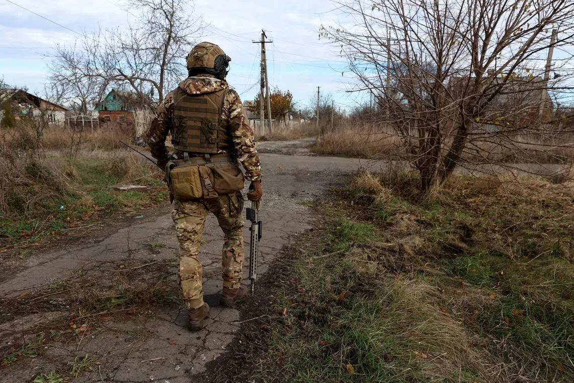 A Ukrainian serviceman walks to a position in the front line town of Avdiivka,  in Ukraine's Donetsk region.