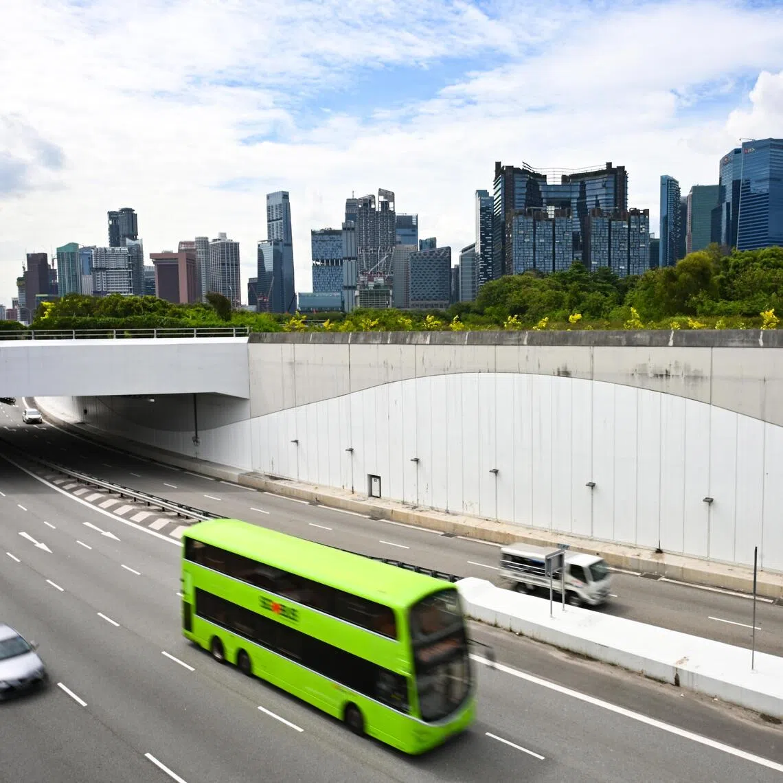 ST20251023-202588400444-Lim Yaohui-pixgeneric/ Generic photograph of vehicles travelling in the Marina Coastal Expressway (MCE) with buildings in the Marina Bay Financial Centre and Central Business District on Oct 23, 2025. Can be used for stories on transport, COE, car, bus, fare, money, population, property, land, commercial, office, invest, budget, income, bank, finance, financial, CBD, URA, population, economy, and development. (ST PHOTO: LIM YAOHUI)