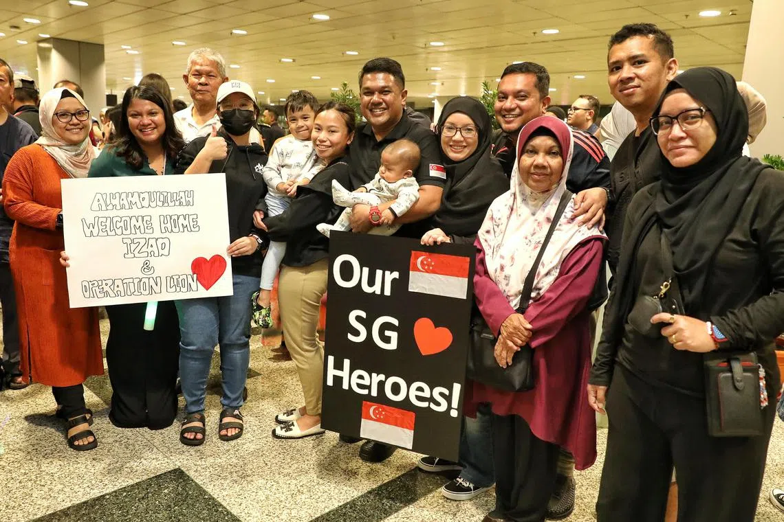 SCDF officer Mohd Rohaizad bin Mansor (centre) received by his family and his wife Mdm Sabrina Musthpa (6th from left) and two children at Changi Airport T3 after returning from Operation Lionheart in Turkey.