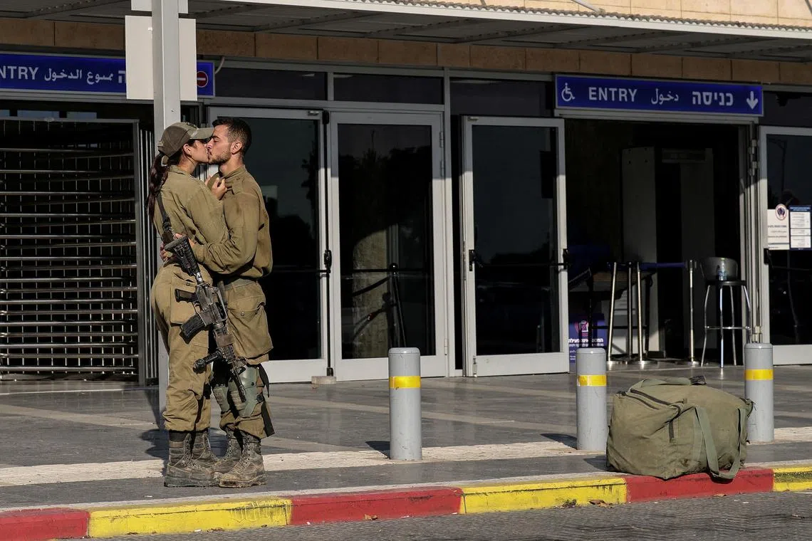 Israeli soldiers kissing by a train station, amid the ongoing conflict between Israel and the Palestinian Islamist group Hamas, in Ashkelon in southern Israel on Oct 16.      