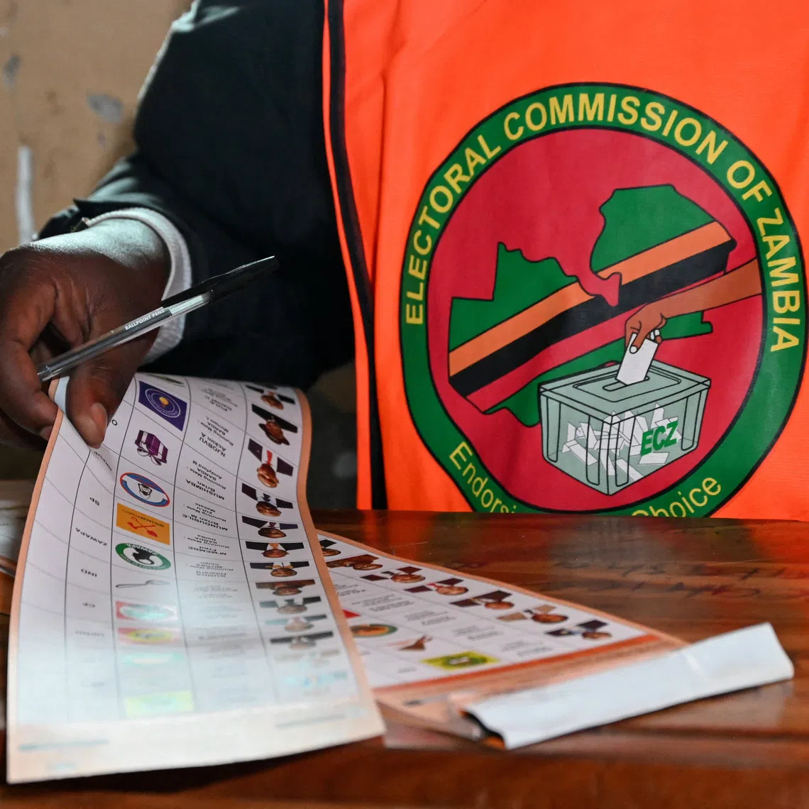 An election official holds a ballot at a polling station during Zambia's general elections, including a presidential election, in Lusaka, Zambia, August 13, 2026. REUTERS/Moses Mwape