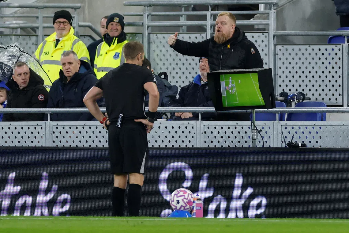 FILE PHOTO: Soccer Football - Premier League - Everton v Tottenham Hotspur - Hill Dickinson Stadium, Liverpool, Britain - October 26, 2025 Referee Craig Pawson checks the VAR screen before disallowing Everton's first goal scored by Everton's Jake O'Brien Action Images via Reuters/Jason Cairnduff/ File Photo