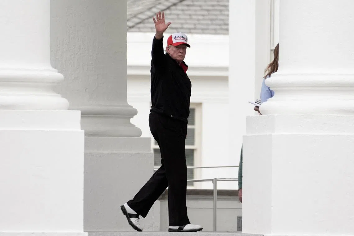 U.S. President Donald Trump gestures while wearing a hat that reads \"Gulf of America\", as he returns to the White House, in Washington, D.C., U.S., April 20, 2025. REUTERS/Ken Cedeno